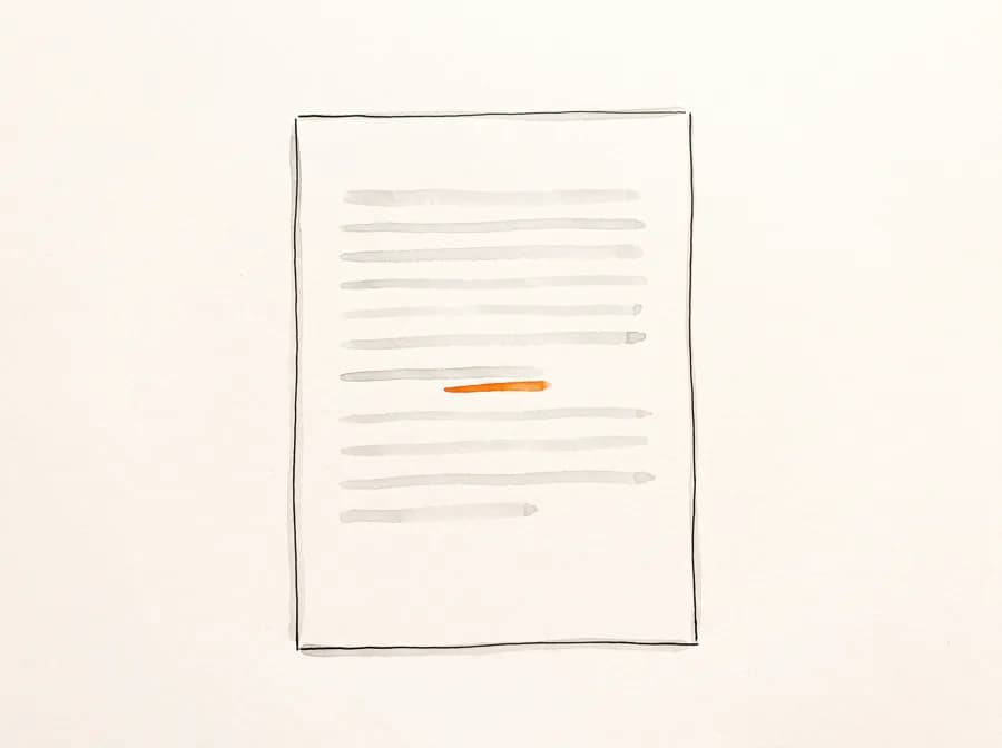 A single sheet of paper, seen from above, with one line marked in orange.